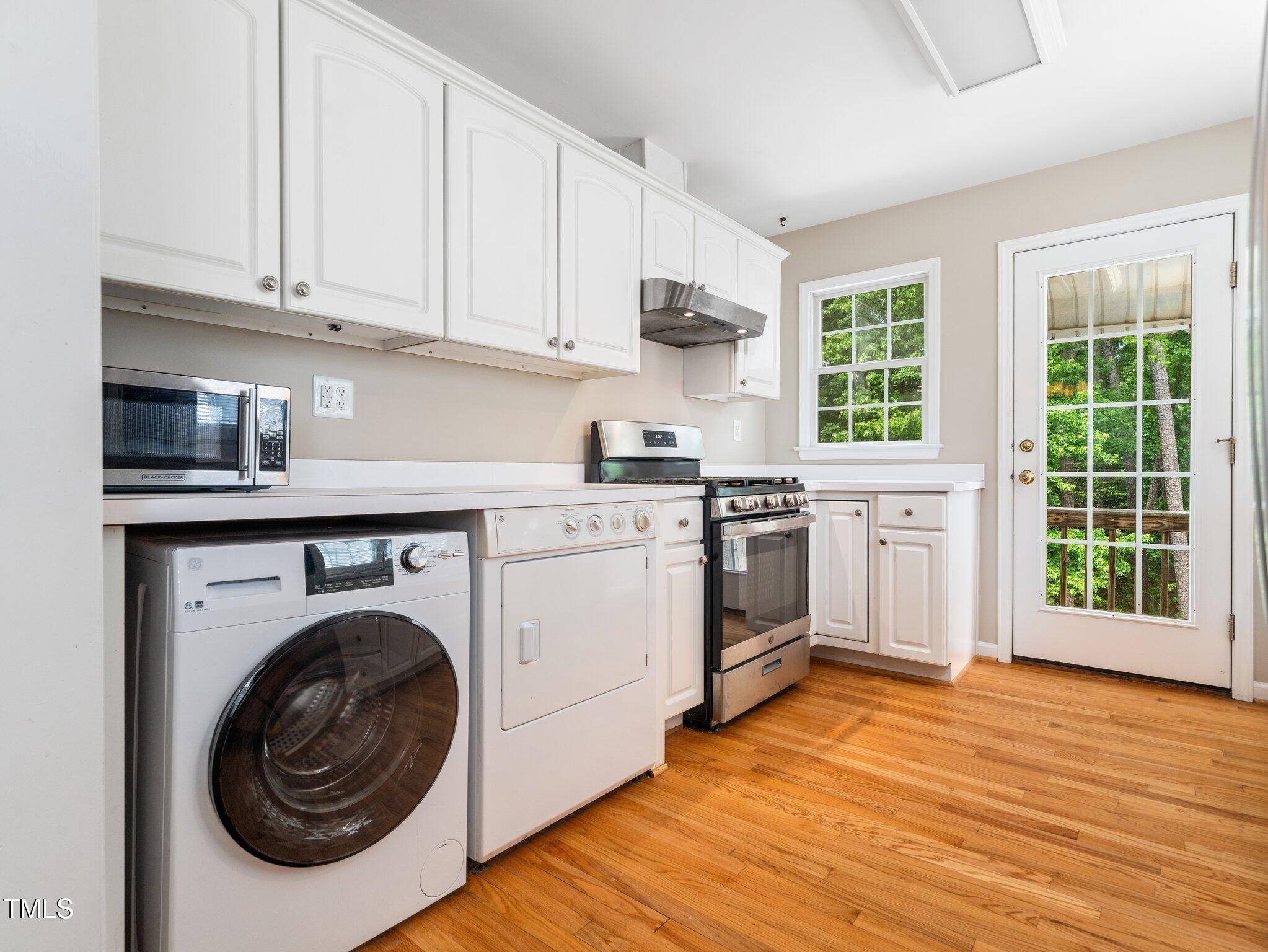 1313 Ridge Road Raleigh, NC 27607 - Photo 12 of 36 a kitchen with a stove top oven sink and cabinets