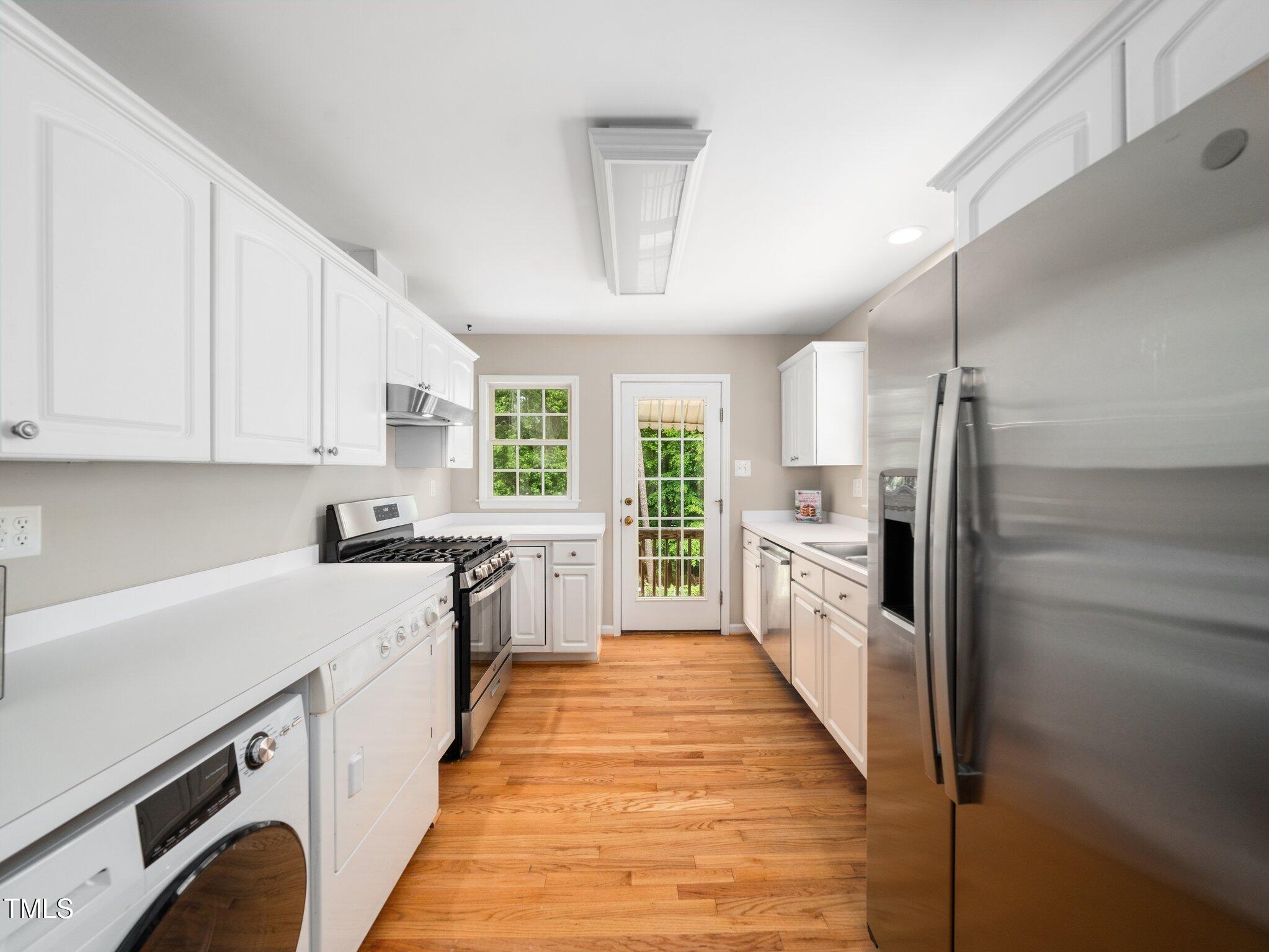 1313 Ridge Road Raleigh, NC 27607 - Photo 13 of 36 a large kitchen with cabinets and stainless steel appliances
