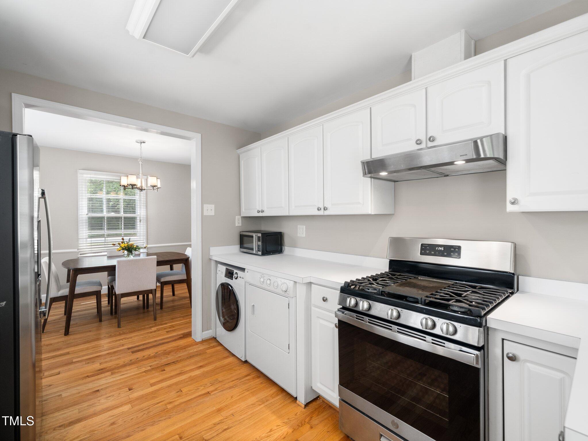 1313 Ridge Road Raleigh, NC 27607 - Photo 15 of 36 a kitchen with cabinets appliances and wooden floor