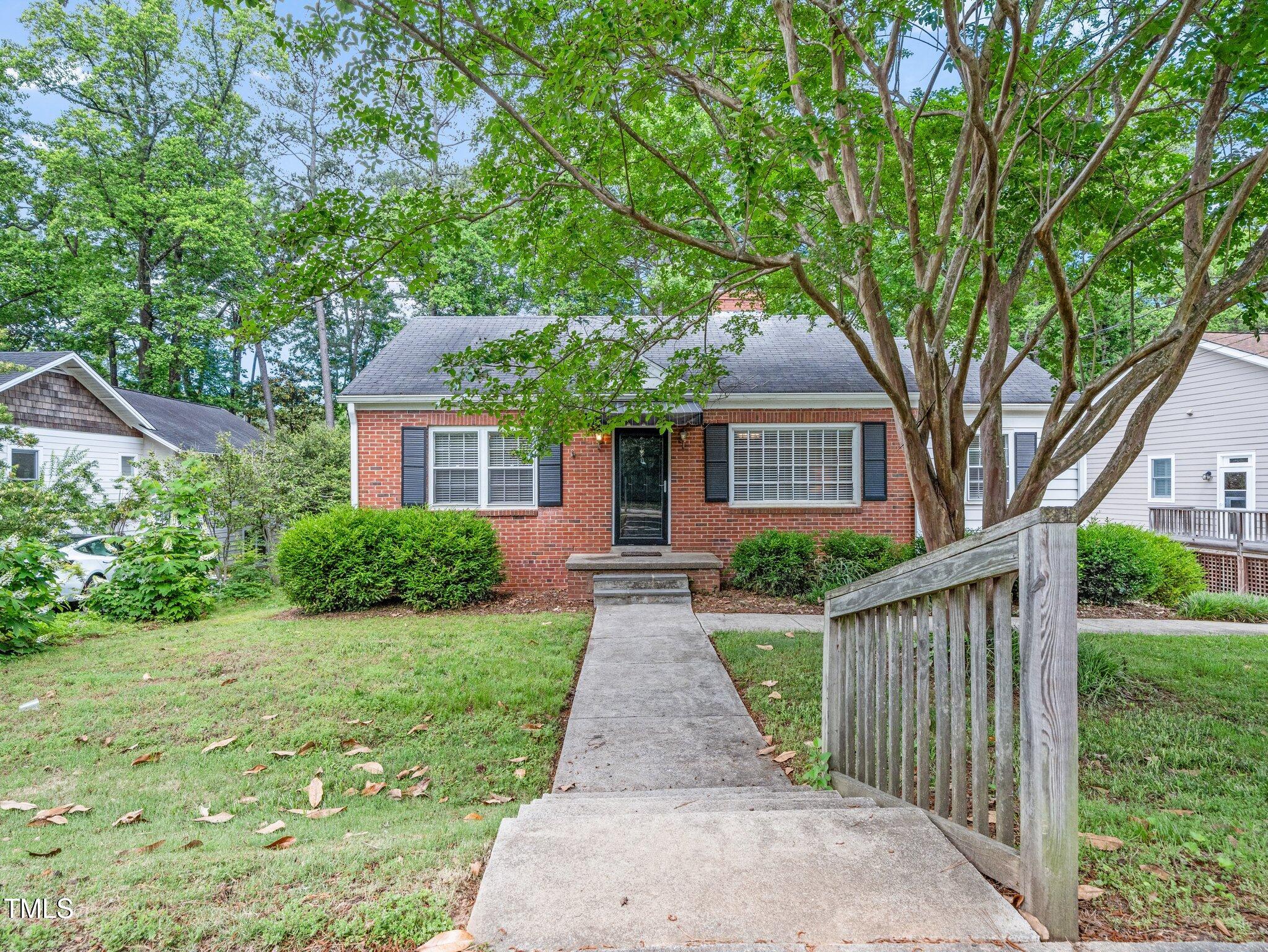 1313 Ridge Road Raleigh, NC 27607 - Photo 2 of 36 front view of a house with yard and an trees