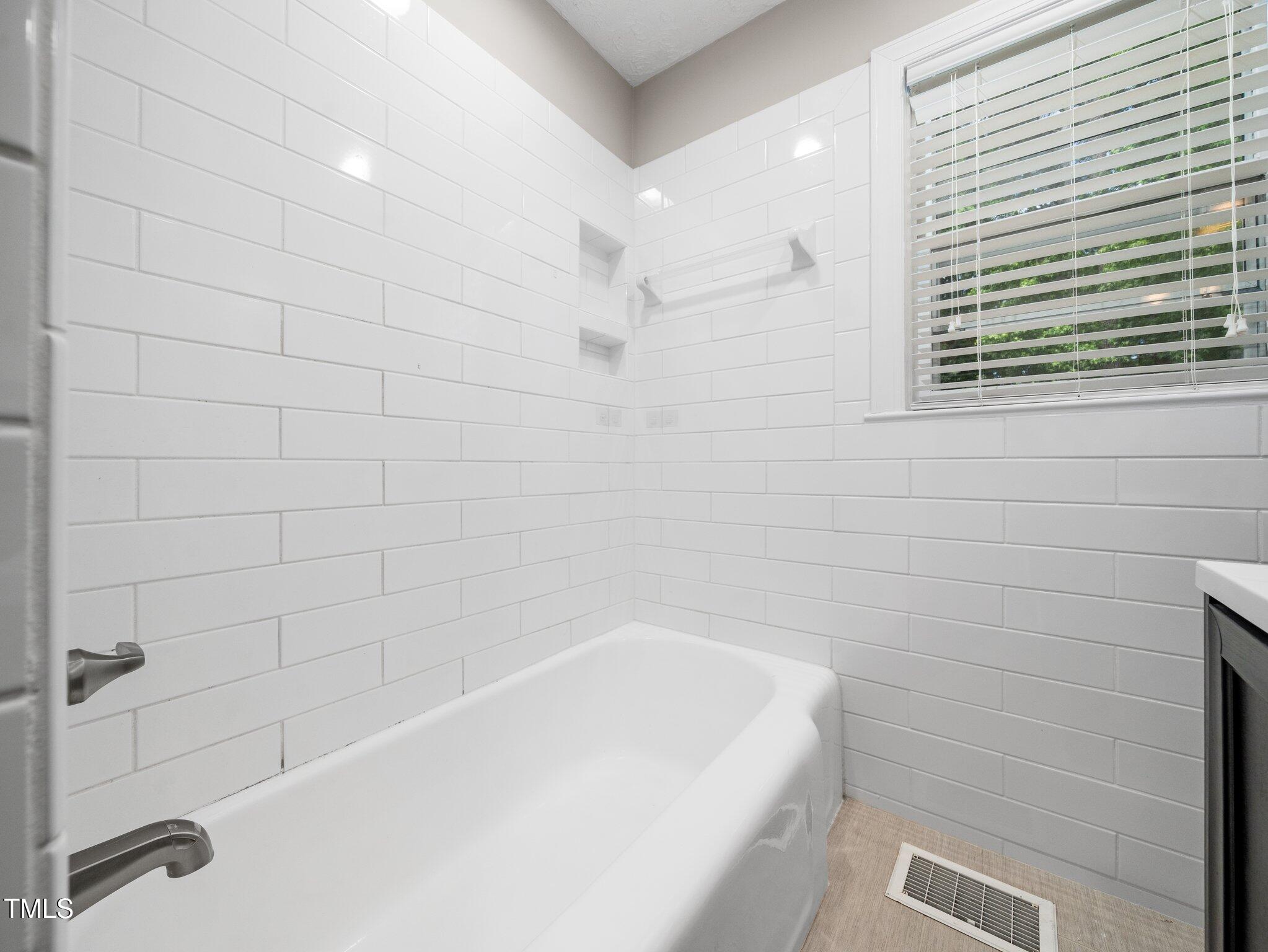 1313 Ridge Road Raleigh, NC 27607 - Photo 21 of 36 a bathroom with a bathtub