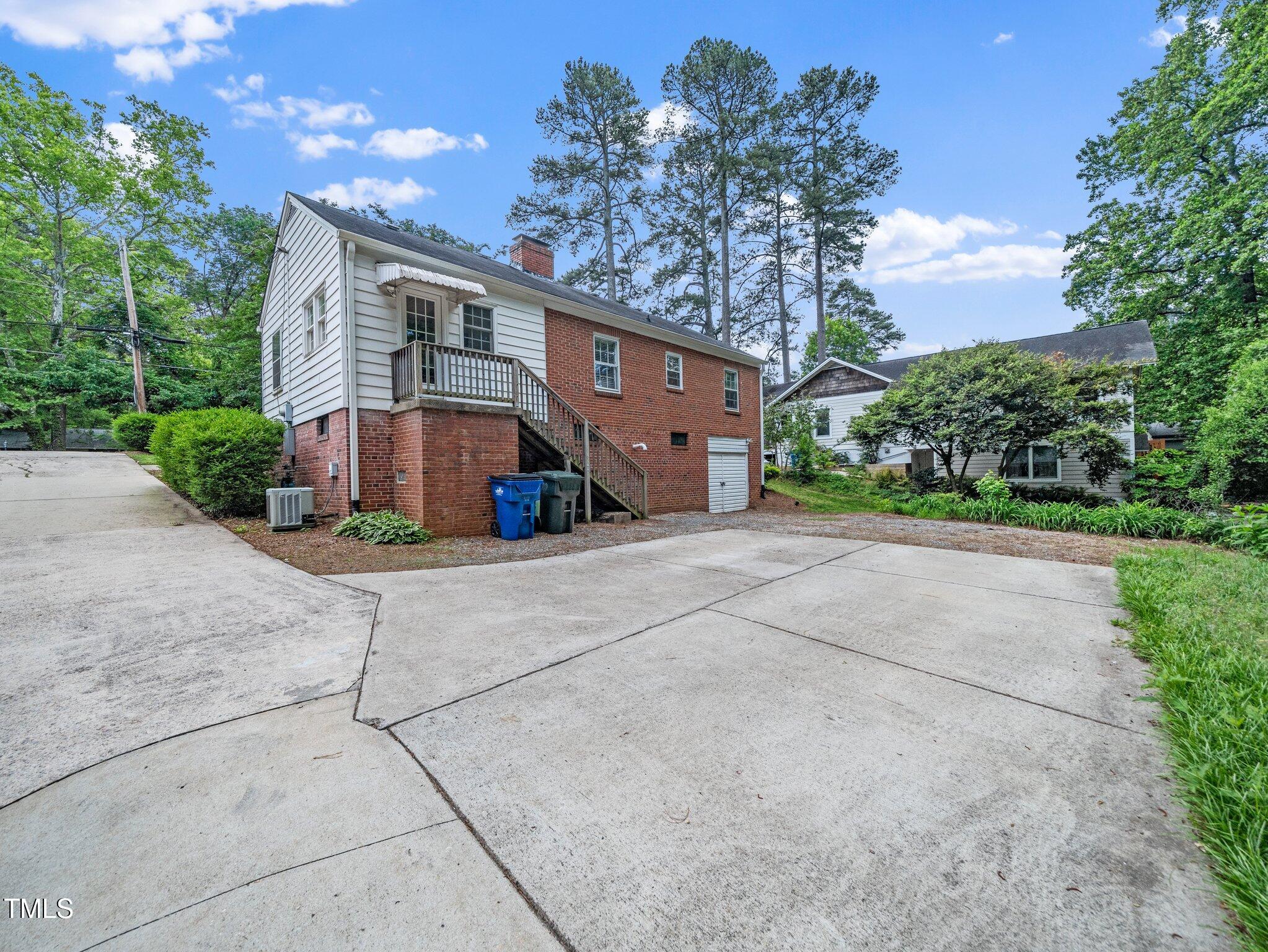 1313 Ridge Road Raleigh, NC 27607 - Photo 30 of 36 a front view of a house with a yard and a garage
