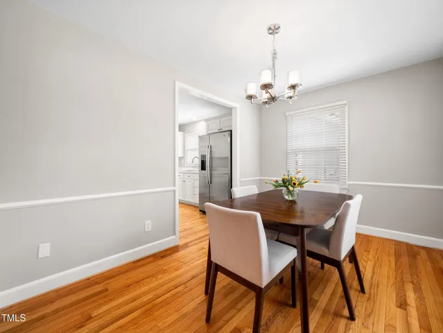 a view of a dining room with furniture and a chandelier