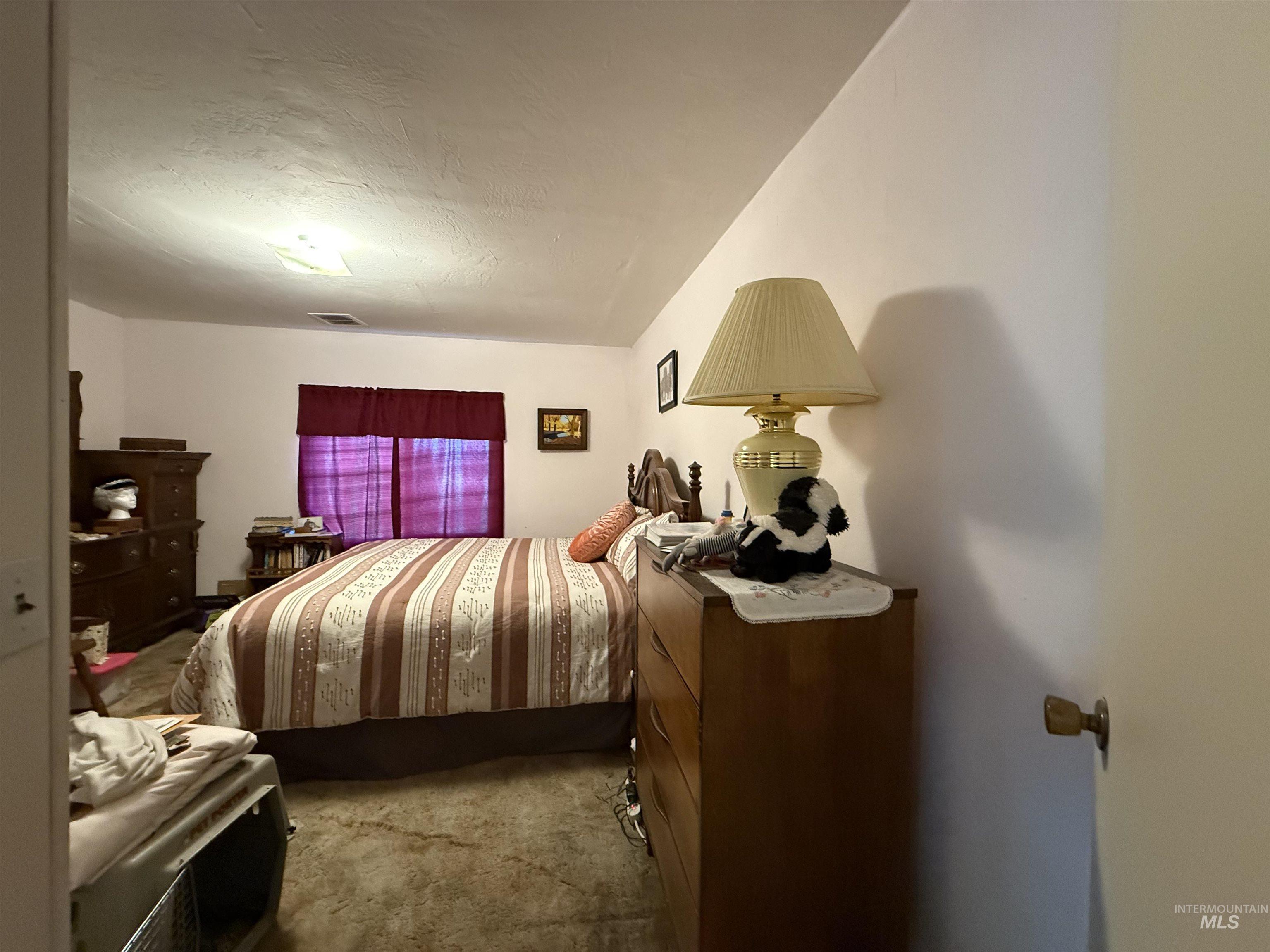 19241 West Homedale Road Caldwell, ID 83607 - Photo 21 of 35 Bedroom featuring dark carpet