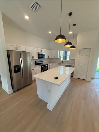 a large kitchen with stainless steel appliances