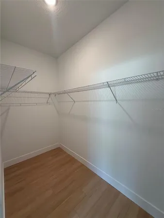 a spacious bathroom with double vanity a mirror a shower and vanity