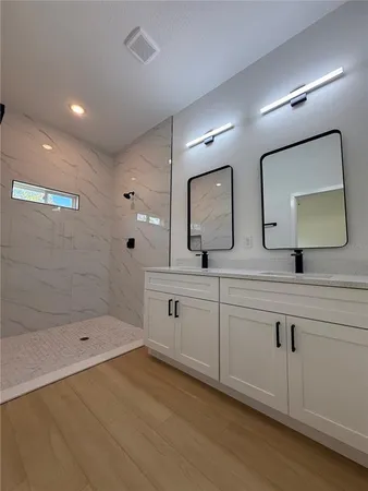 a bathroom with a sink a mirror and vanity