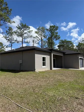 a house that has a tree in front of it