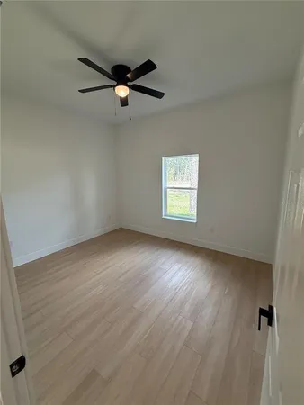 a view of an empty room with a ceiling fan