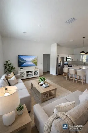 a bedroom with a bed a couch and window