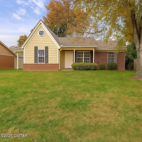 a view of a yard in front of a house with large trees