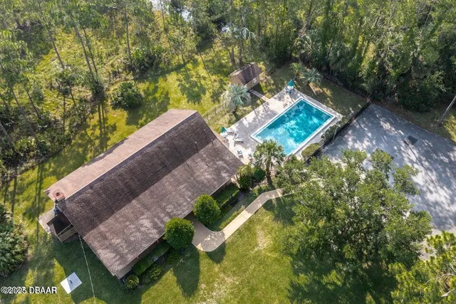 aerial view of a house with a yard