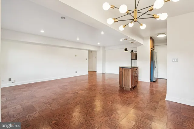 a kitchen with stainless steel appliances granite countertop a refrigerator a stove and a sink