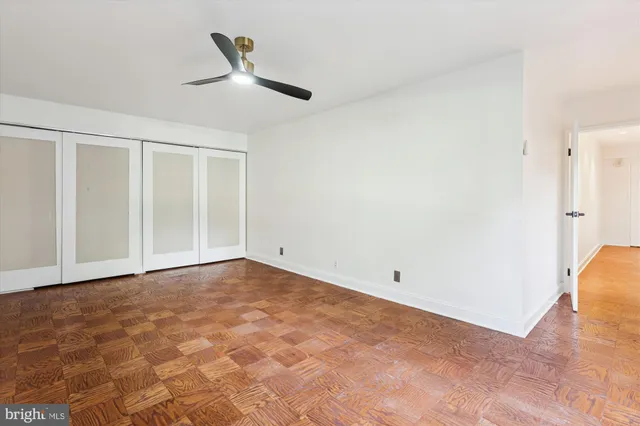 a bathroom with a granite countertop sink a toilet a mirror and shower