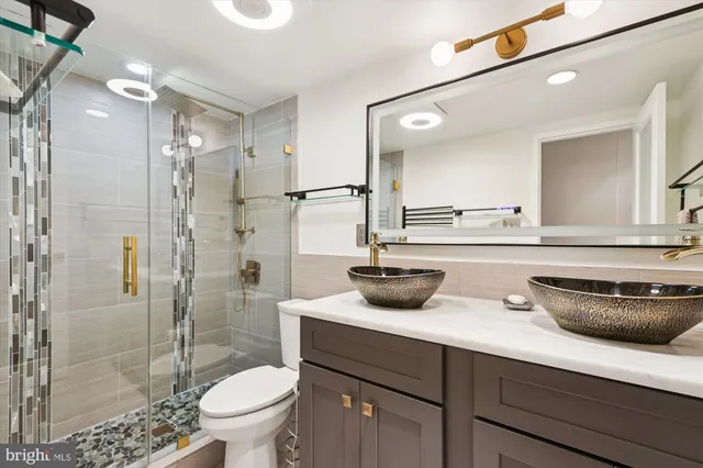 a bathroom with a sink toilet and shower