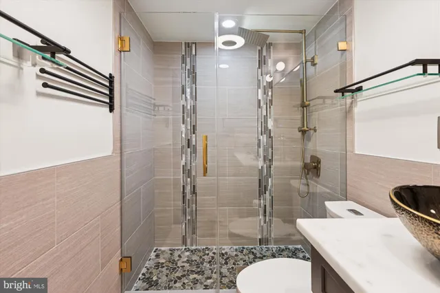 a living room with a couch and a potted plant