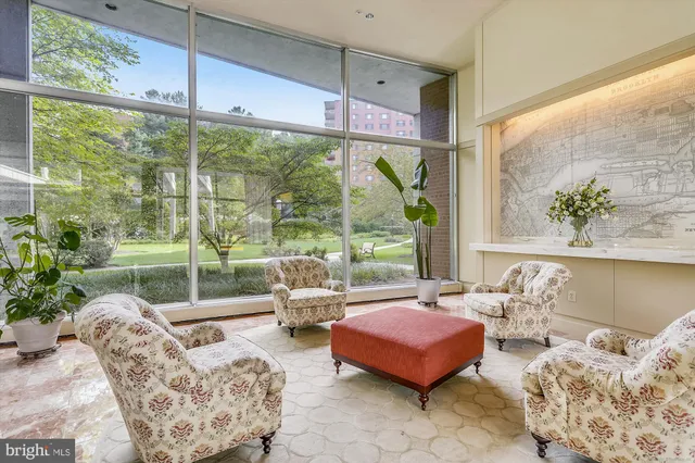 a bedroom with furniture and large windows