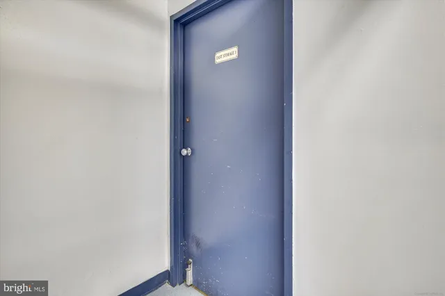 a view of a cafe with a table and chairs under an umbrella