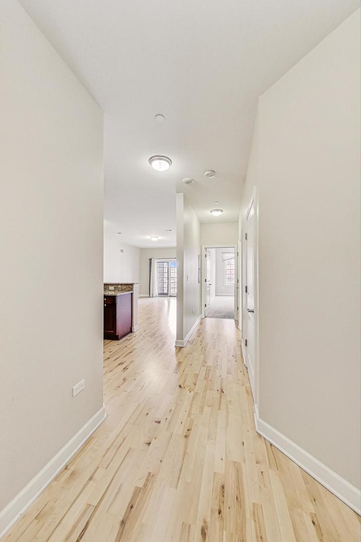 50 North Plum Grove Road, Unit 210E Palatine, IL 60067 - Photo 13 of 47 a view of empty room with wooden floor