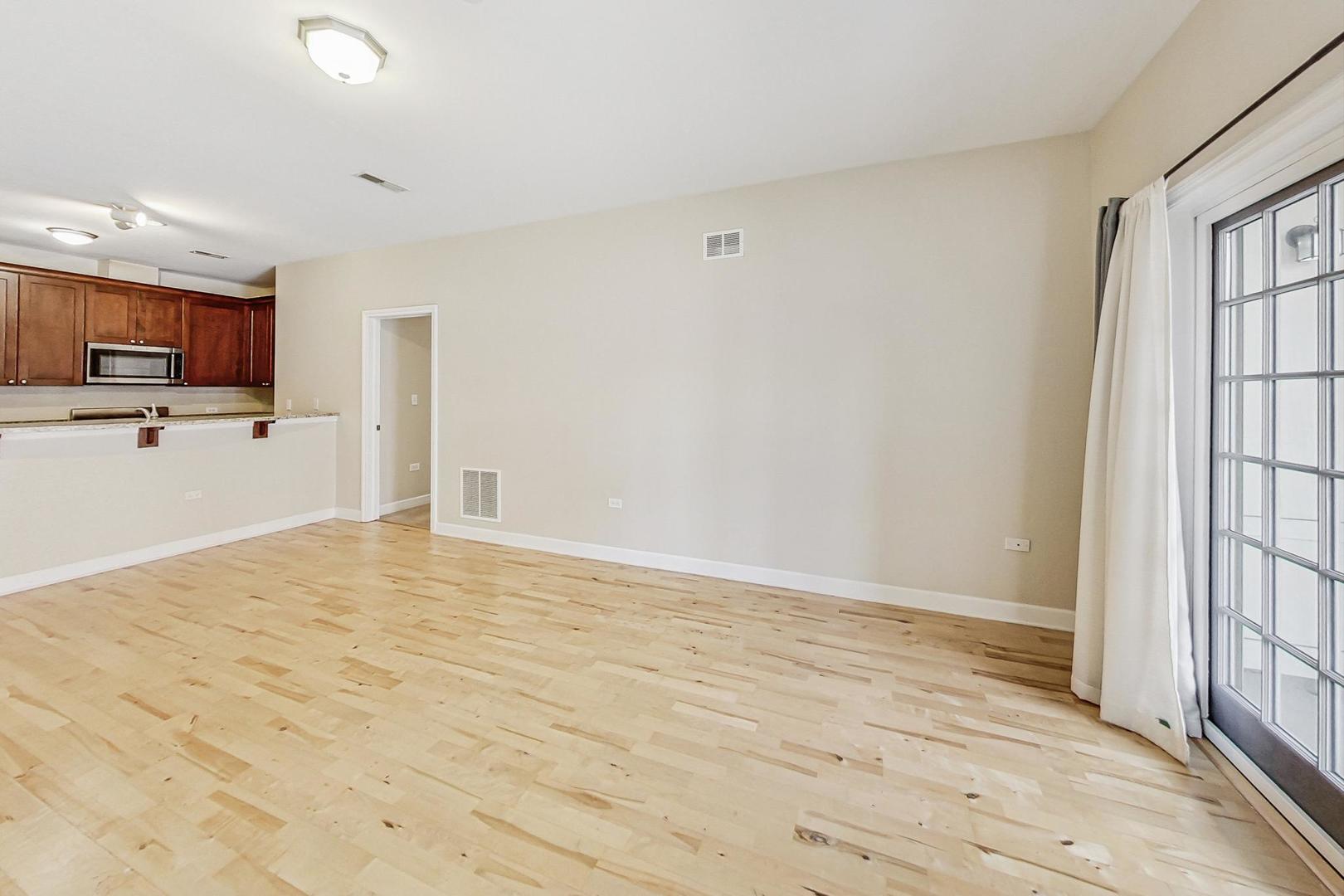 50 North Plum Grove Road, Unit 210E Palatine, IL 60067 - Photo 16 of 47 a view of kitchen with wooden floor and electronic appliances