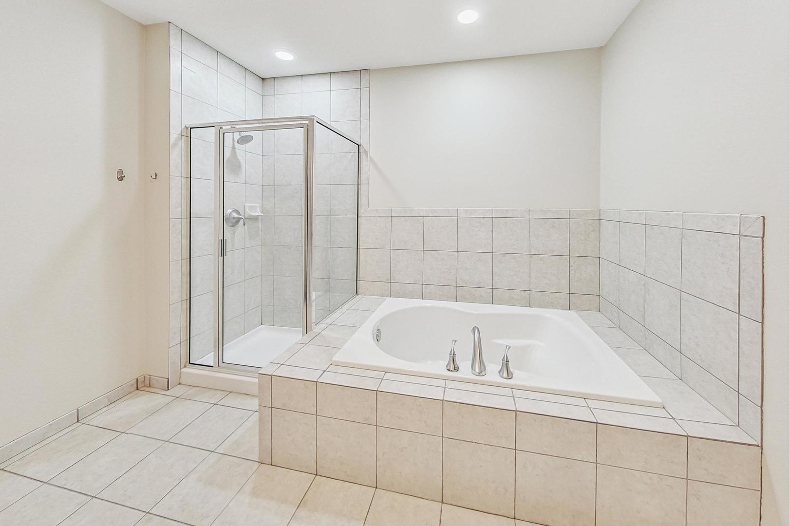 50 North Plum Grove Road, Unit 210E Palatine, IL 60067 - Photo 27 of 47 a bathroom with a bathtub and a shower