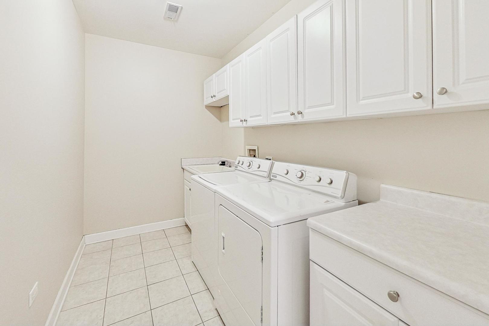 50 North Plum Grove Road, Unit 210E Palatine, IL 60067 - Photo 33 of 47 a utility room with dryer and washer