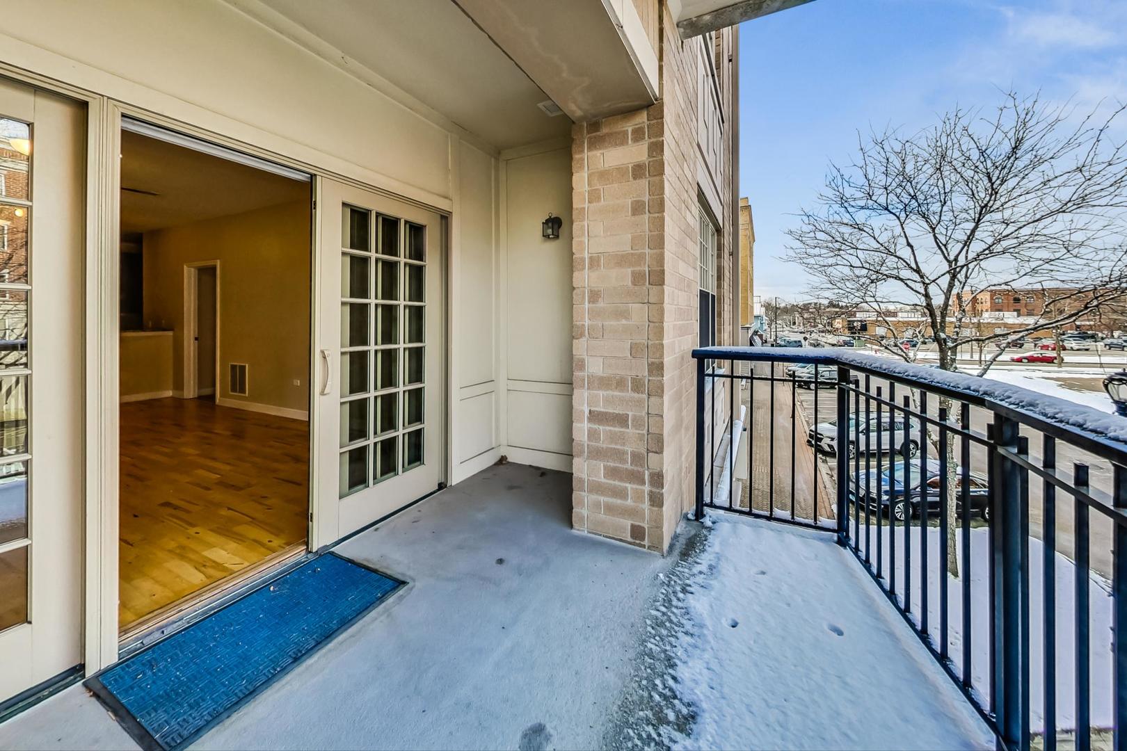 50 North Plum Grove Road, Unit 210E Palatine, IL 60067 - Photo 35 of 47 a view of a porch with wooden floor and fence