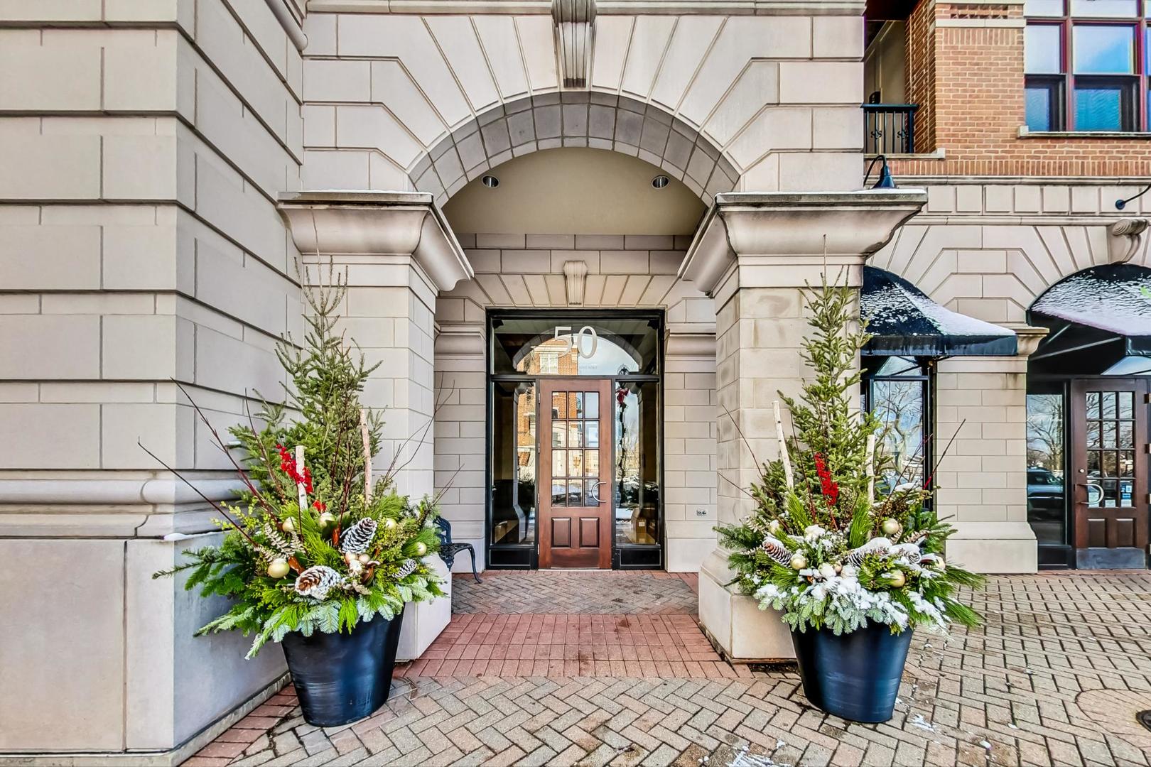 50 North Plum Grove Road, Unit 210E Palatine, IL 60067 - Photo 7 of 47 a vase with flowers sitting on a floor in front of a house
