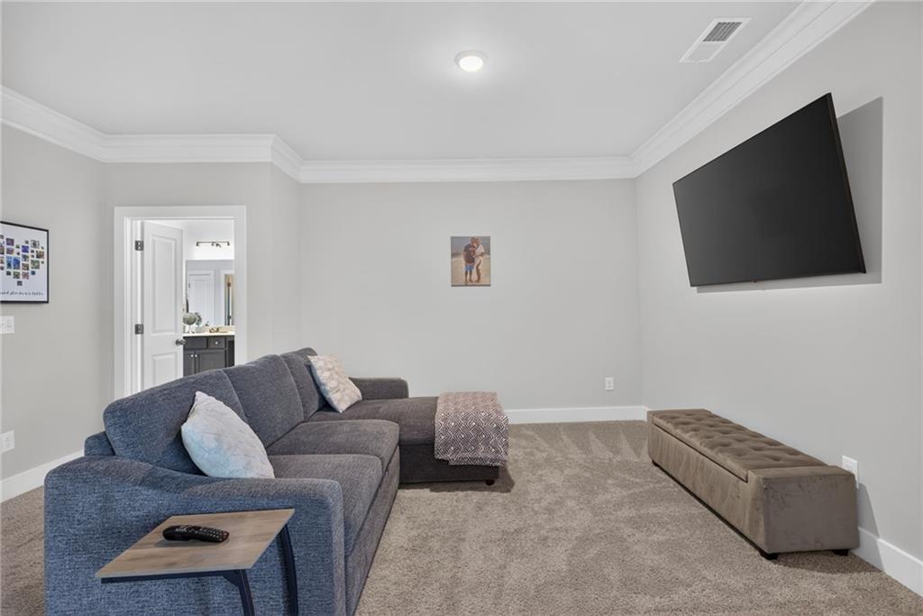 139 Manchester Lane Villa Rica, GA 30180 - Photo 32 of 60 a living room with furniture and a flat screen tv