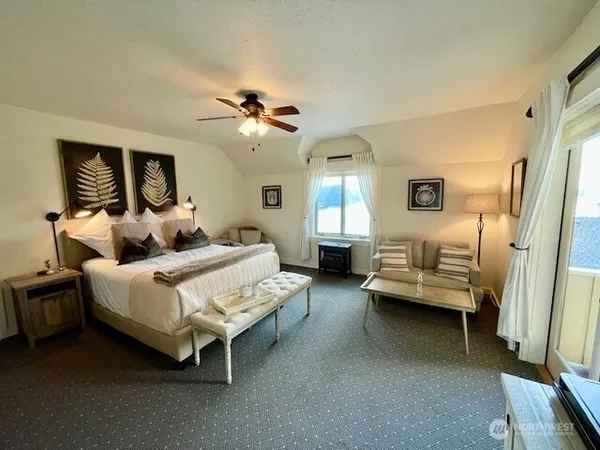 a bedroom with bed couch and window