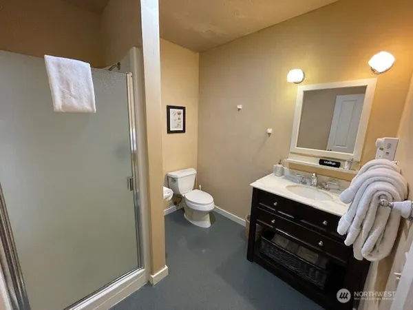 a bathroom with a sink a toilet and mirror
