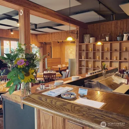 a view of a swimming pool with a table and chairs and potted plants