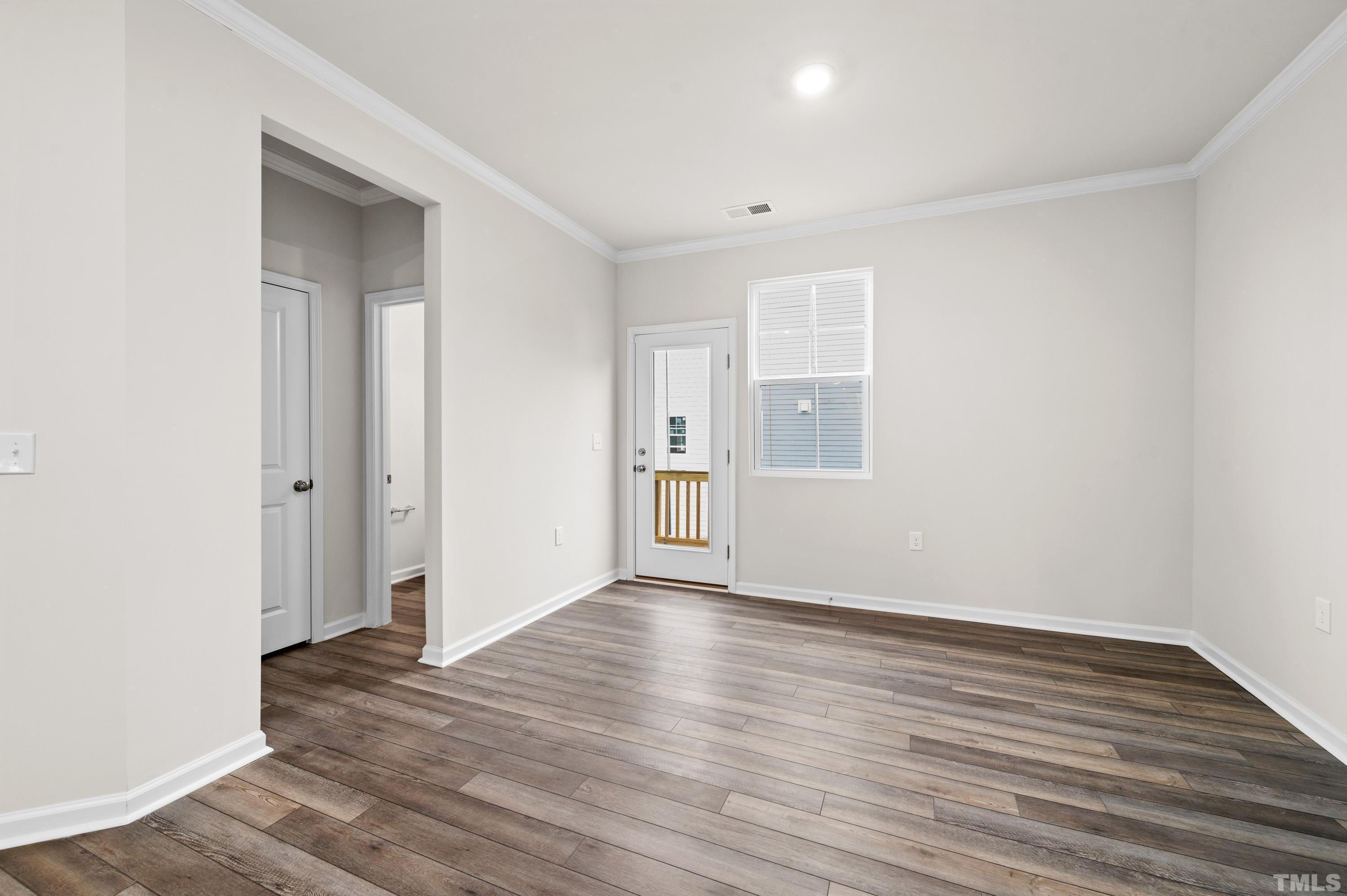 414 Odham Lane Wake Forest, NC 27587 - Photo 13 of 29 a view of an empty room with wooden floor and a window