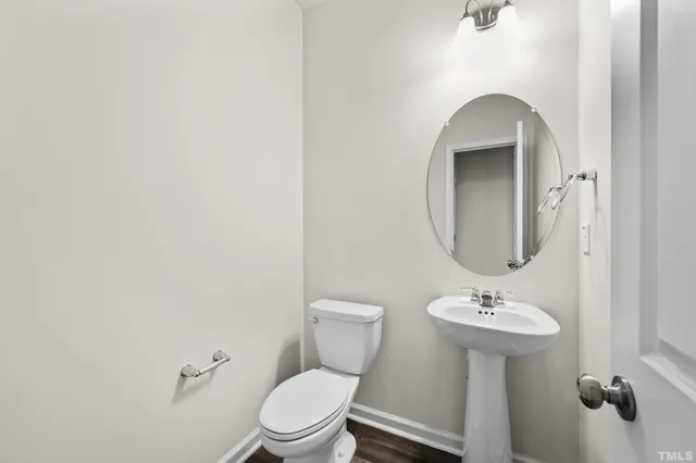 a bathroom with a sink toilet and a mirror