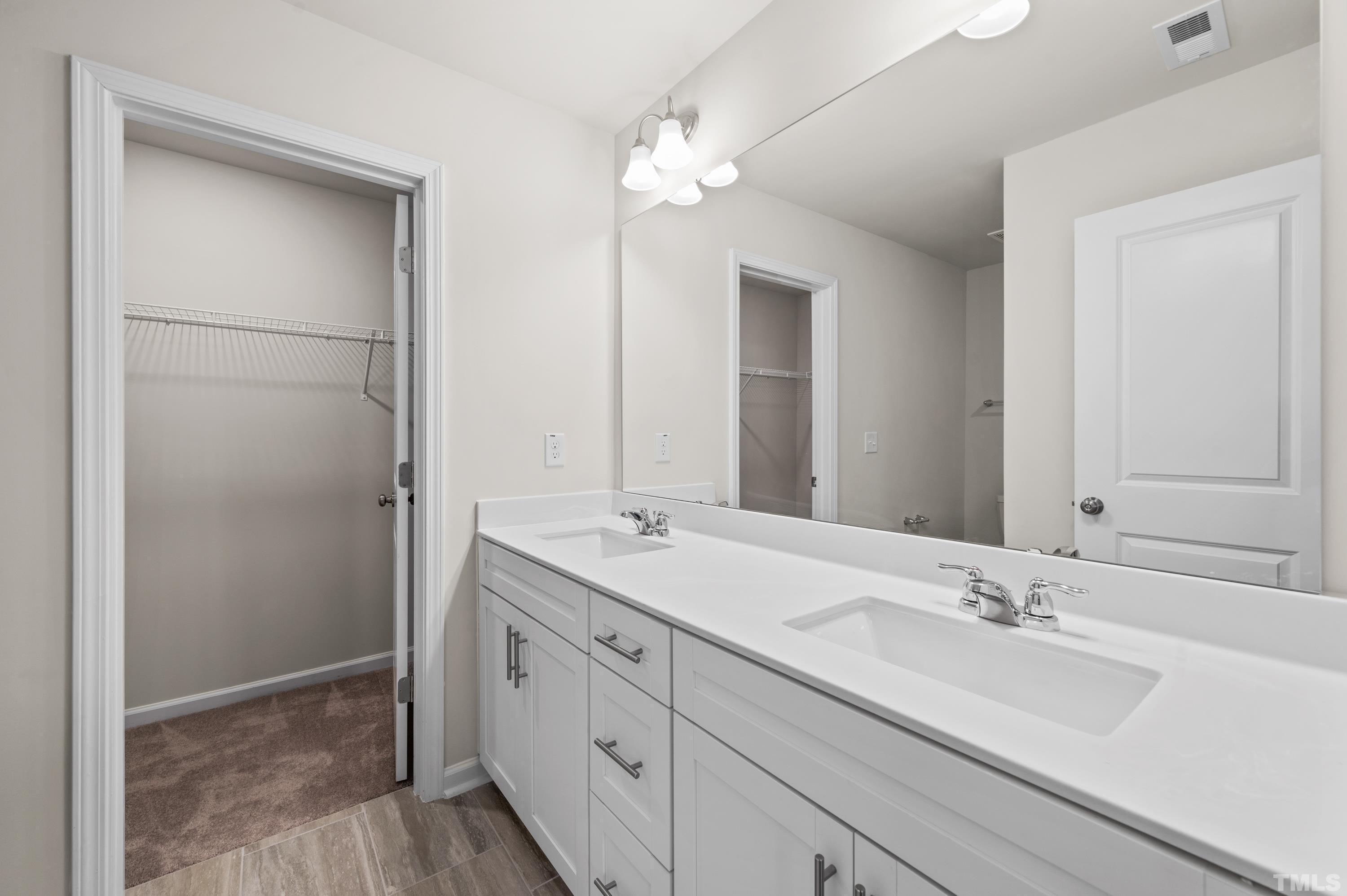 414 Odham Lane Wake Forest, NC 27587 - Photo 18 of 29 a bathroom with a double vanity sink and mirror
