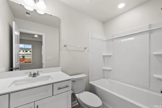 a bathroom with a sink a toilet and bathtub