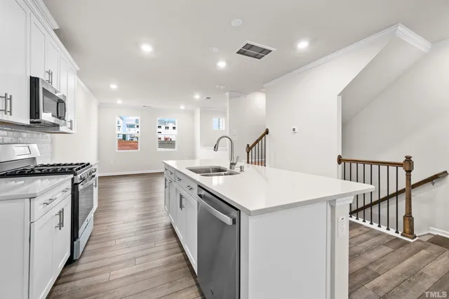 a kitchen with sink stove and oven