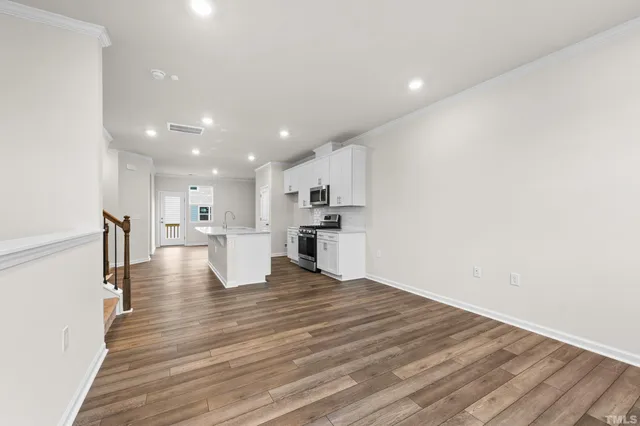 a view of kitchen dining table chairs microwave and cabinets