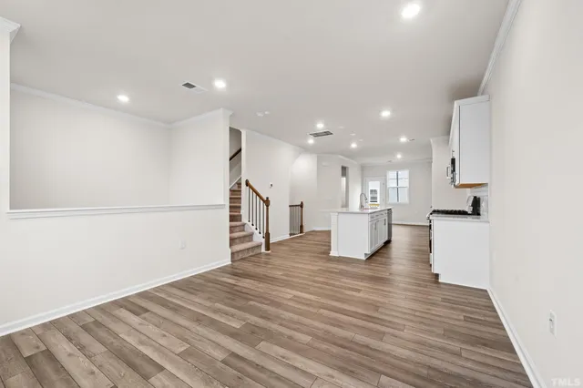 a view of kitchen with kitchen island sink and wooden floor