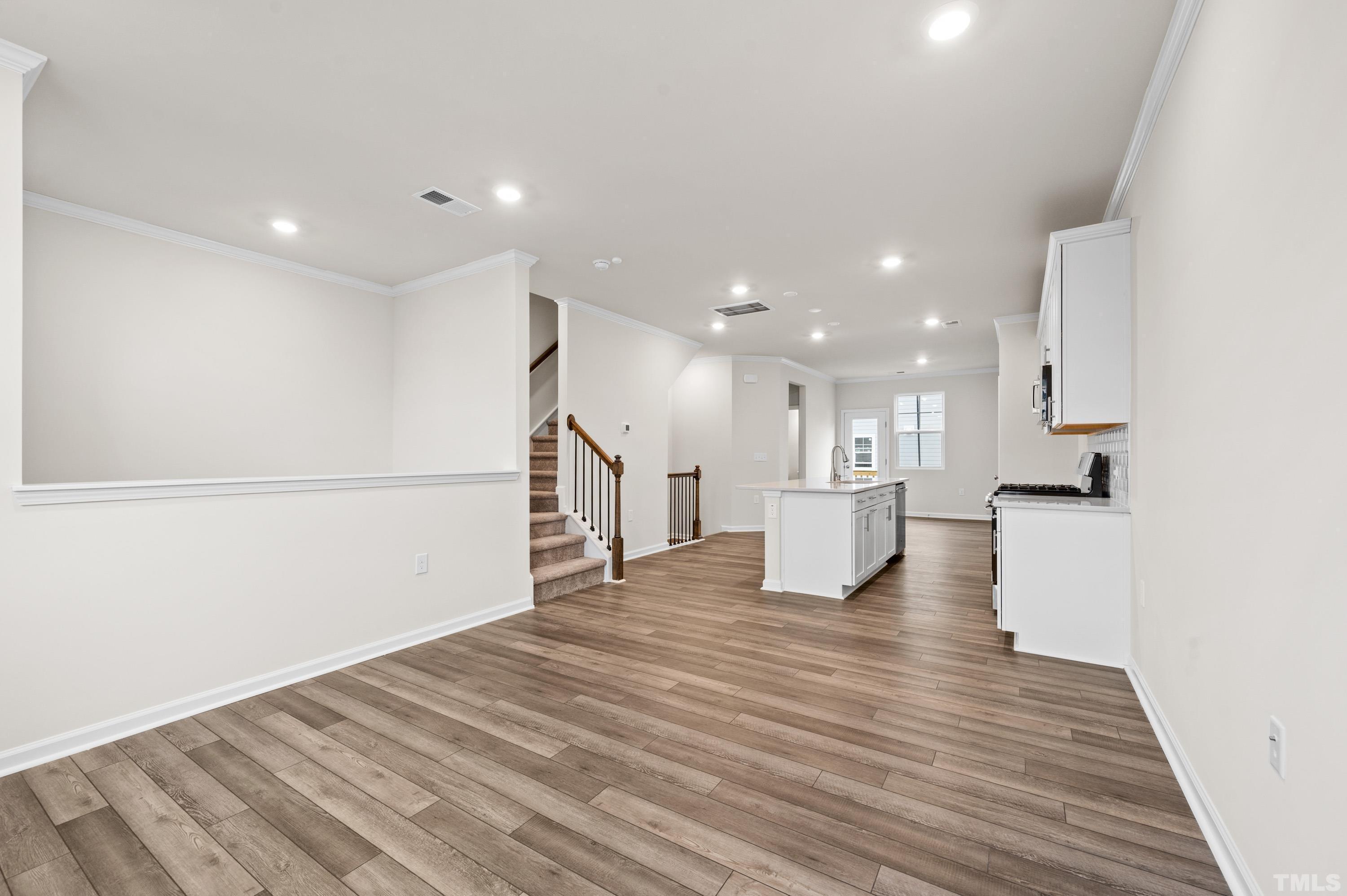 414 Odham Lane Wake Forest, NC 27587 - Photo 9 of 29 a view of kitchen with kitchen island sink and wooden floor