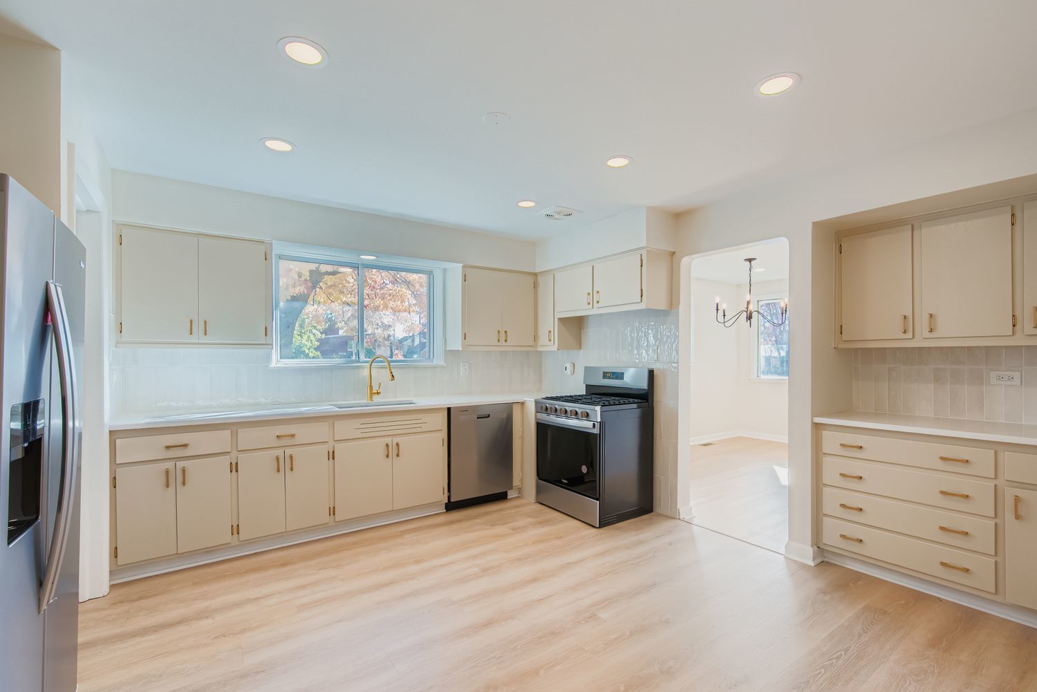 3600 West 115th Street Chicago, IL 60655 - Photo 5 of 17 a large kitchen with cabinets wooden floor and stainless steel appliances