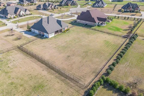 an aerial view of a house with a swimming pool