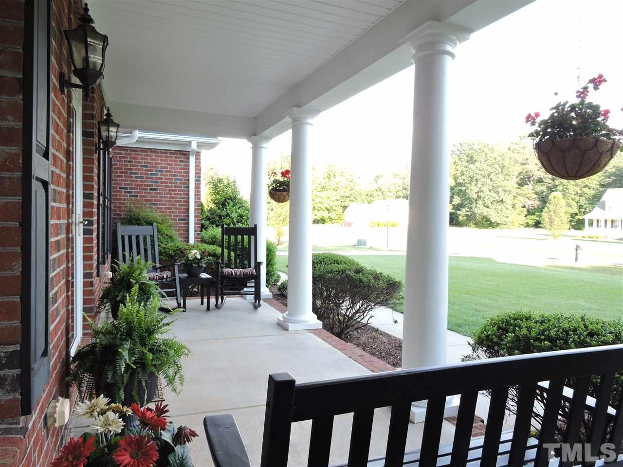 170 Fletcher Ridge Road Timberlake, NC 27583 - Photo 2 of 25 a view of a porch with chairs and potted plants