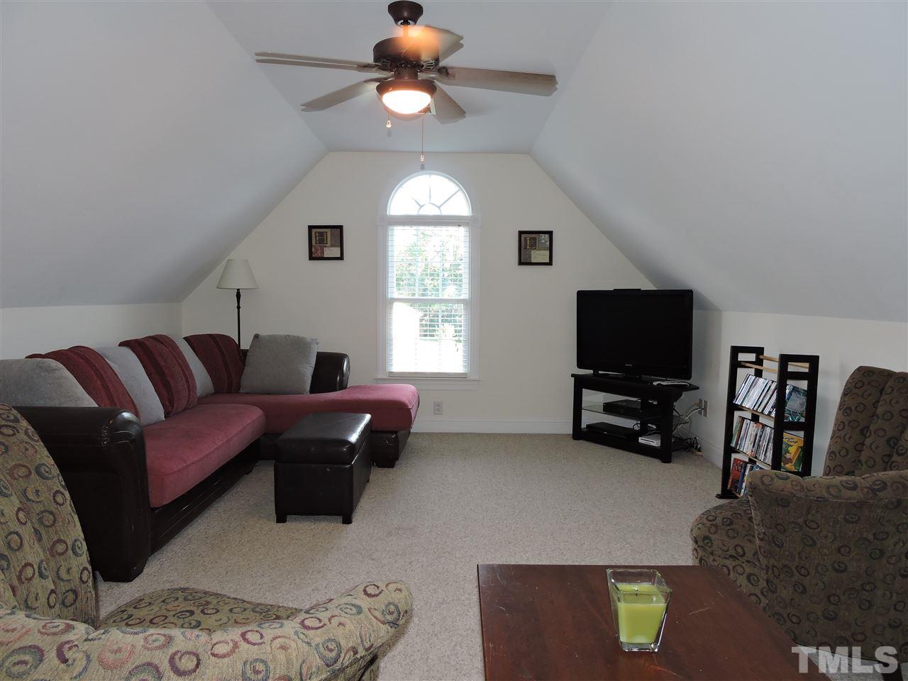 170 Fletcher Ridge Road Timberlake, NC 27583 - Photo 20 of 25 a living room with furniture and a flat screen tv