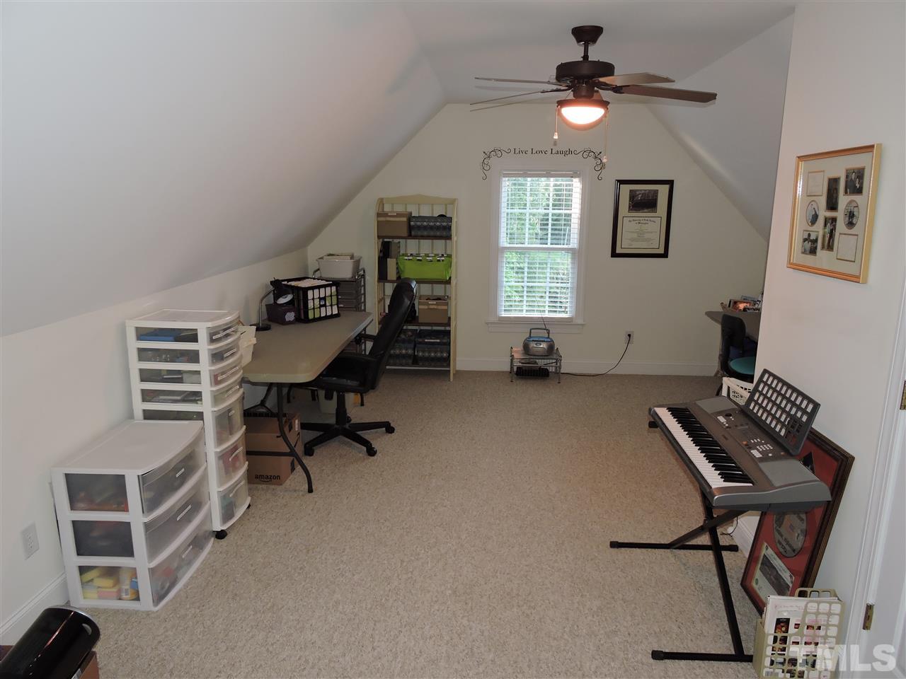 170 Fletcher Ridge Road Timberlake, NC 27583 - Photo 21 of 25 a room with furniture a desk and chair