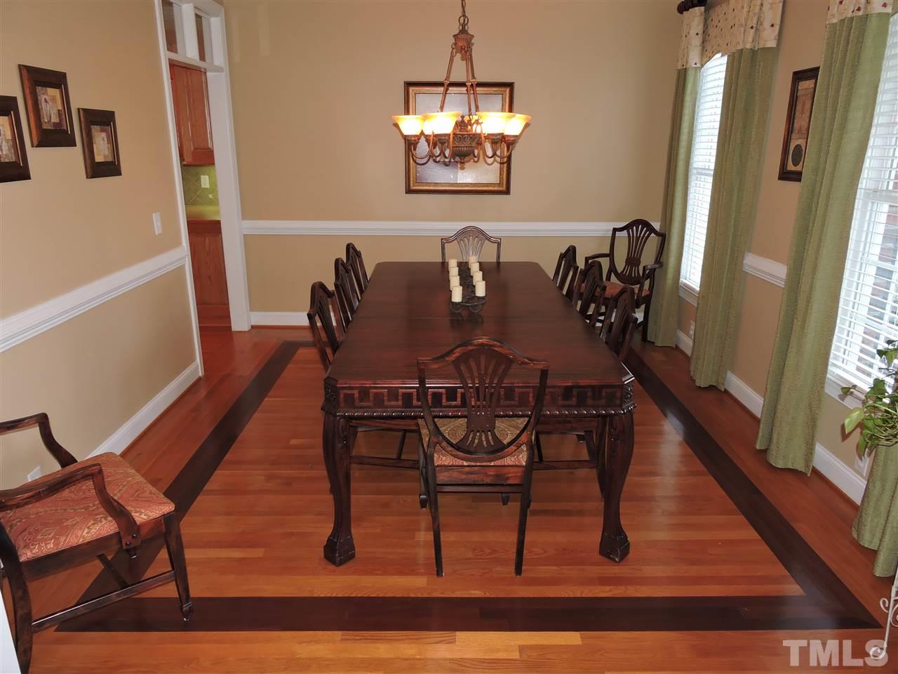 170 Fletcher Ridge Road Timberlake, NC 27583 - Photo 8 of 25 a dining room with furniture a rug and wooden floor