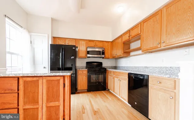 a view of a kitchen with a sink stove and kitchen view