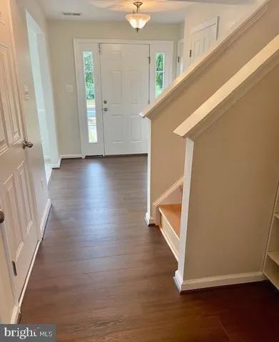a view of an entryway with wooden floor