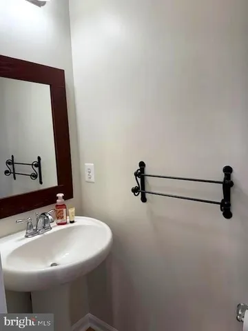 a bathroom with a sink and mirror