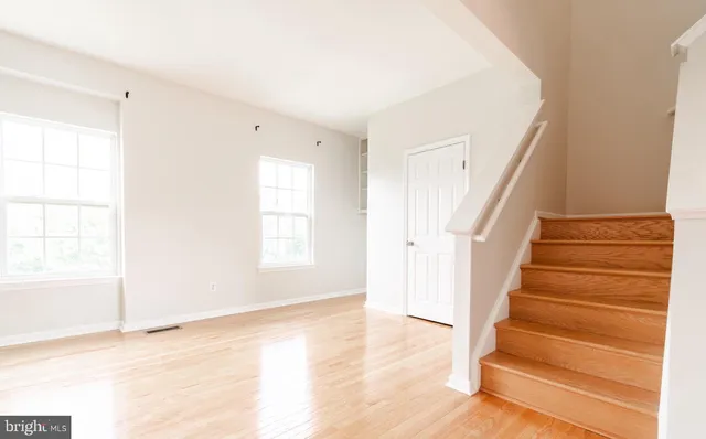 a view of an entryway with wooden floor and door